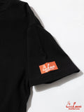 Black t-shirt with a red and white logo on a white background