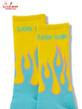 Pair of yellow and blue socks with flame design on a white background and Bjorn Qorn in text