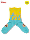Turquoise socks with flame design and yellow accents on a white background with Bjorn Qorn lettering
