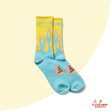Blue and yellow socks with flame design on a light yellow background