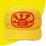 Yellow cap with red logo and text on a yellow background