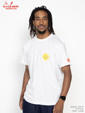 Man wearing a white t-shirt with logos on a plain background