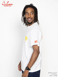 Man wearing a white t-shirt with logos on a plain background
