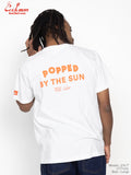 Person wearing a white t-shirt with 'Popped by the Sun' text on the back, standing against a white background.